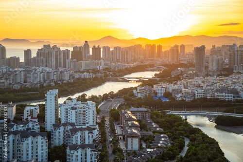 Aerial view of Sanya city with river at sunset light, Hainan province, China