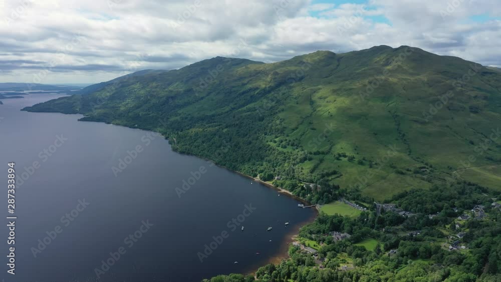 Aerial view of Loch Lomond, picturesque scene with lake and lush green hills - landscape panorama of Loch Lomond & The Trossachs National Park from above, Scotland, United Kingdom,Great Britain,Europe Aerial view of Loch Lomond, picturesque scene with lake and lush green hills - landscape panorama of Loch Lomond & The Trossachs National Park from above, Scotland, United Kingdom,Great Britain,Europe