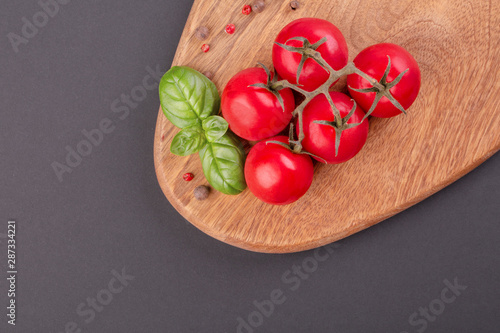 Pieces of Rigiano parmesan, cherry tomato and basil leaf
