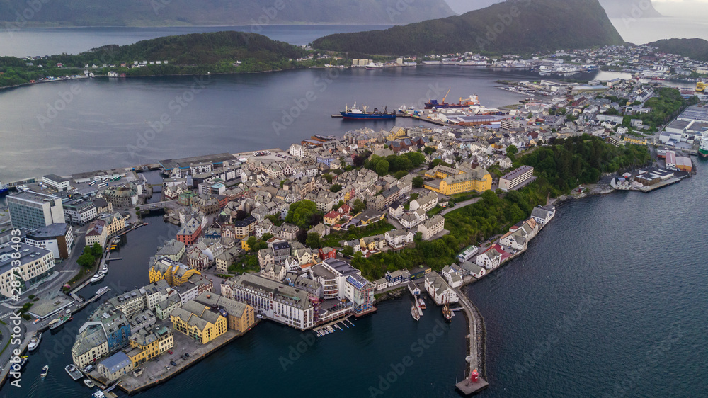 Alesund, Norway. Aerial view of Alesund, Norway at sunrise. Colorful sky over famous tourisitc destination with sunlight and mountains