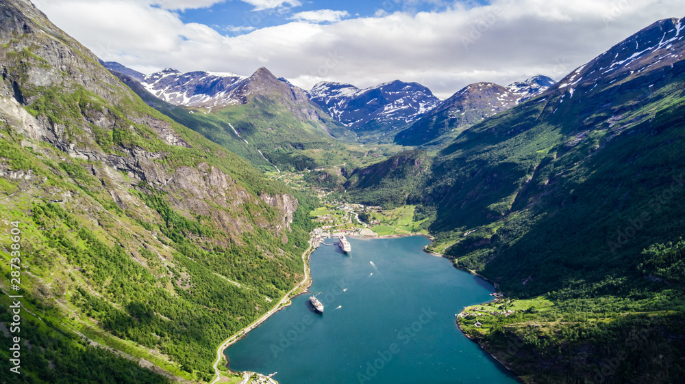 Aerial view of Sunnylvsfjorden fjord canyon, Geiranger village location, western Norway. Aerial evening view of famous Seven Sisters waterfalls. Beauty of nature concept background.