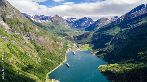 Aerial view of Sunnylvsfjorden fjord canyon, Geiranger village location, western Norway. Aerial evening view of famous Seven Sisters waterfalls. Beauty of nature concept background.