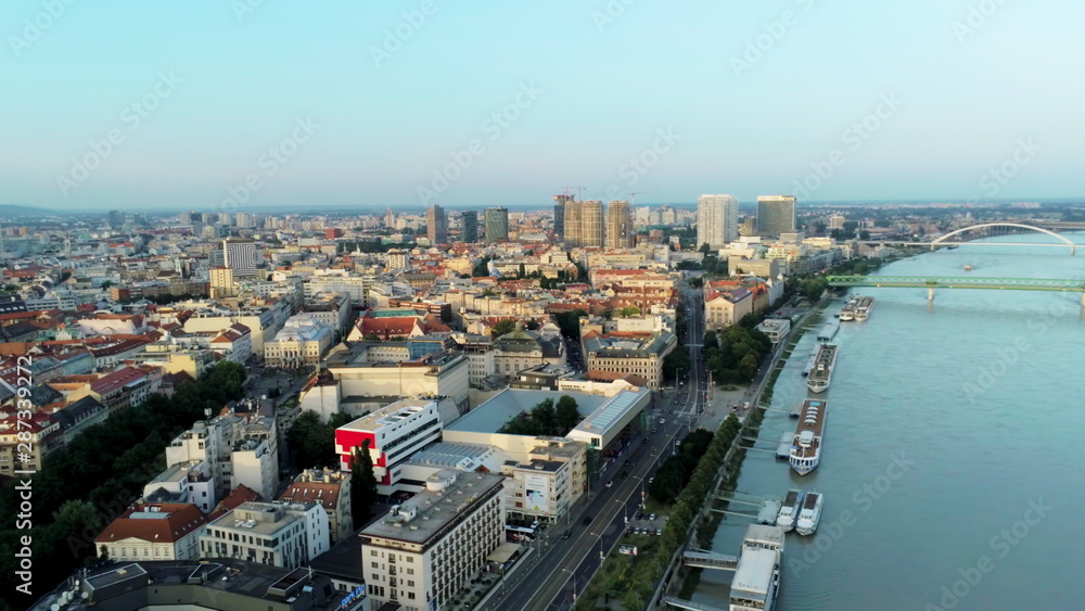 Obraz premium Bratislava Aerial Cityline (Slovakia) over Danube River with Boats and Bridges at Sunset
