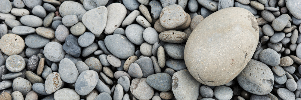 Round stones panoramic background. Gravel texture background Round stones panoramic background. Gravel texture background