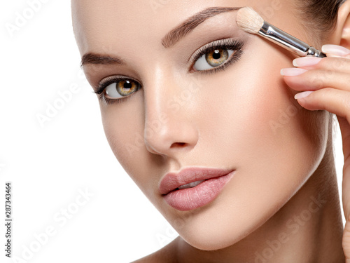 Print op canvas Beautiful woman applying eyeshadow use makeup brush