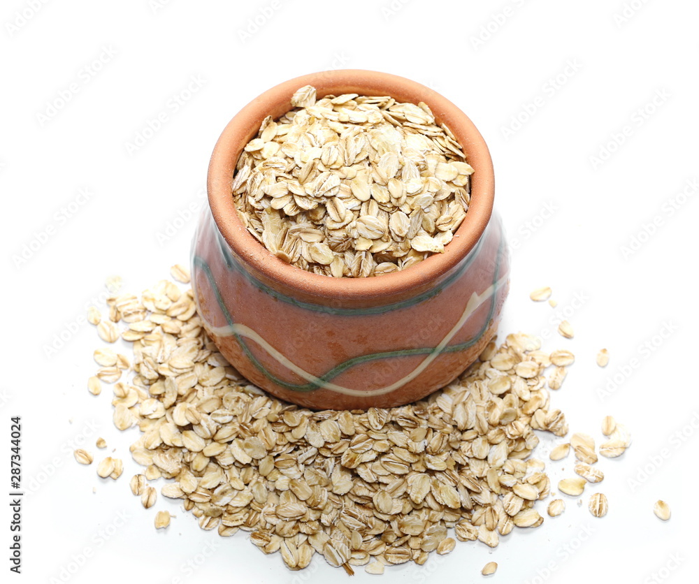 Oats, grain cereal in clay pot isolated on white background Oats, grain cereal in clay pot isolated on white background