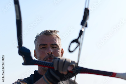 Kite surfer having fun on a beautiful sunny and windy day. Extreme sports and fun. Kitesurfing lessons. Sea and sun. Extreme watersports.