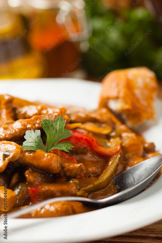 Boeuf, Stroganow, Strogonow. Classic, Russian beef stew. Served on a white plate. Front view. Natural background. Boeuf, Stroganow, Strogonow. Classic, Russian beef stew. Served on a white plate. Front view. Natural background.