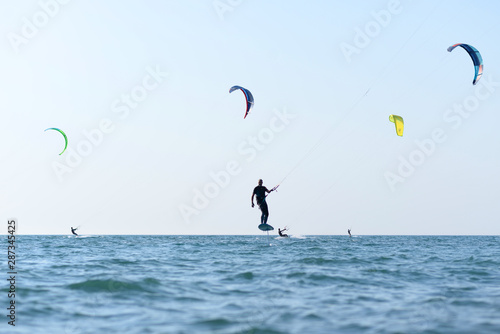 Kite surfer having fun on a beautiful sunny and windy day. Extreme sports and fun. Kitesurfing lessons. Sea and sun. Extreme watersports.