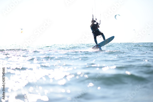 Kite surfer having fun on a beautiful sunny and windy day. Extreme sports and fun. Kitesurfing lessons. Sea and sun. Extreme watersports.