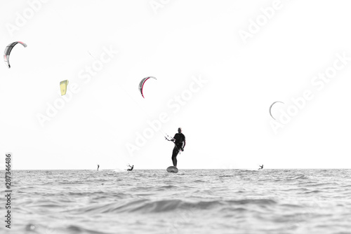 Kite surfer having fun on a beautiful sunny and windy day. Extreme sports and fun. Kitesurfing lessons. Sea and sun. Extreme watersports.