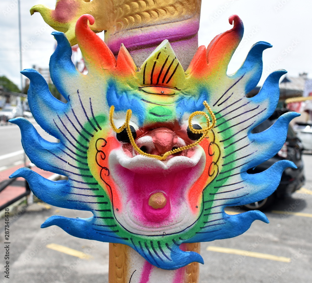Vibrantly colored dragon incense stick at a Chinese festival