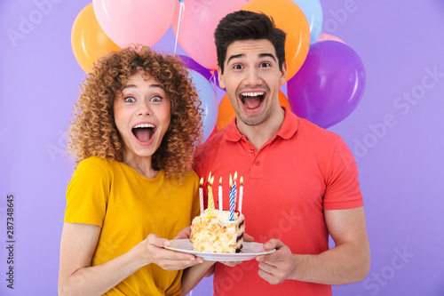 Photography Image of excited couple man and woman celebrating birthday with multicolored air