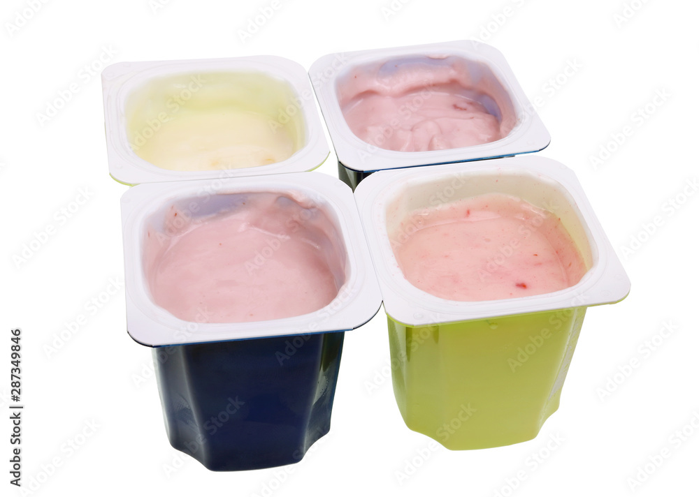 Real cheap nonfat cherry and strawberry yogurt in blue and green open plastic cups isolated macro Real cheap nonfat cherry and strawberry yogurt in blue and green open plastic cups isolated macro