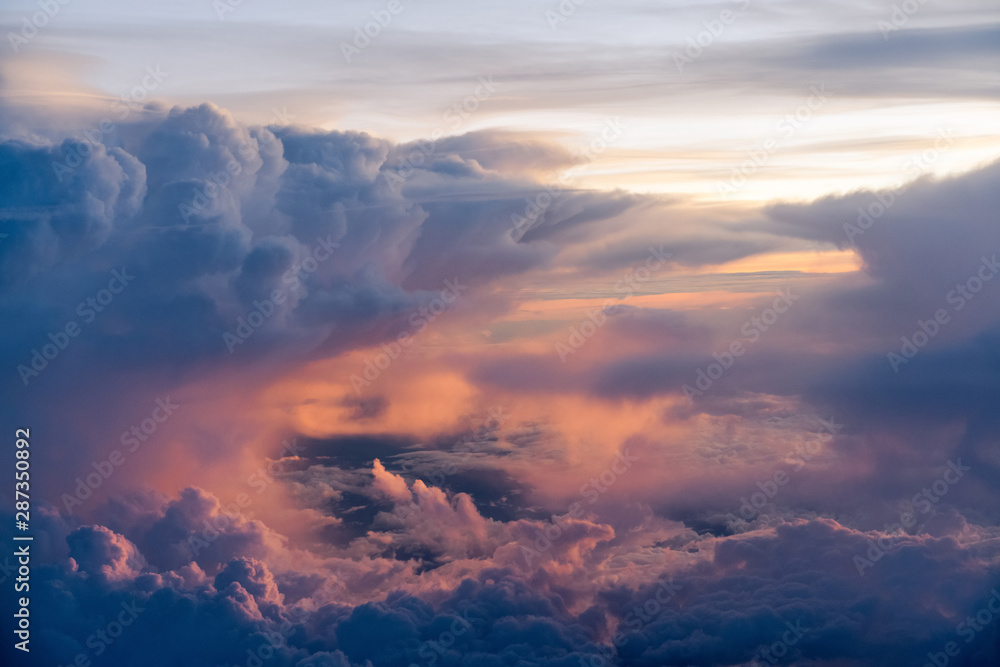 Fototapeta premium Dramatic sky with orange, blue, dark clouds