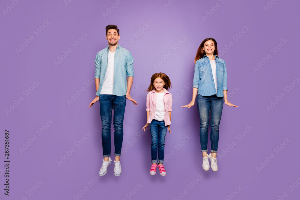 Obraz premium Full size photo of three jumping high family members wear casual clothes isolated purple background