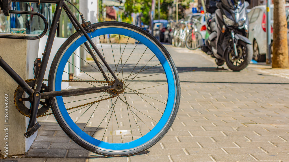 urban life style concept picture with cycle wheel center of composition in street 