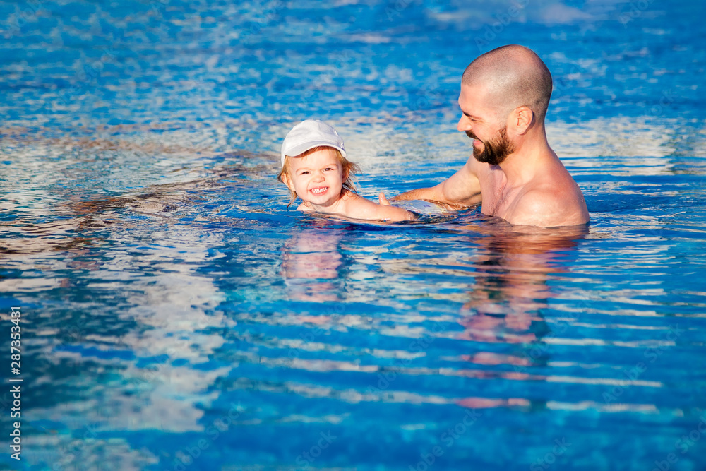 father and daughter in the pool
