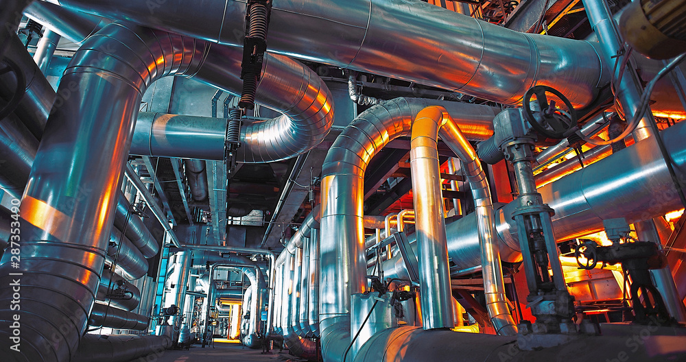 Equipment, cables and piping as found inside of a modern industrial power plant Equipment, cables and piping as found inside of a modern industrial power plant