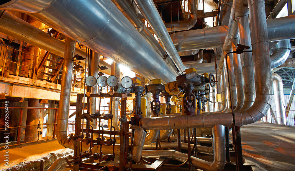 Equipment, cables and piping as found inside of a modern industrial power plant Equipment, cables and piping as found inside of a modern industrial power plant