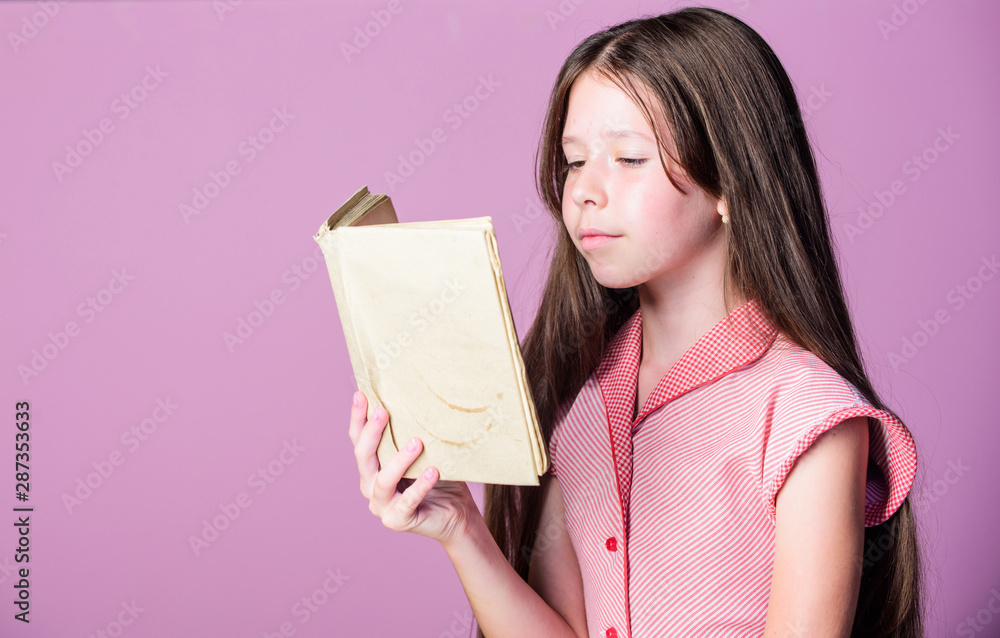 Thirst of knowledge. Adorable bookworm. Reading literature as hobby. Little girl learn reading. Home schooling concept. Fiction and nonfiction. Cute small child reading book on violet background Thirst of knowledge. Adorable bookworm. Reading literature as hobby. Little girl learn reading. Home schooling concept. Fiction and nonfiction. Cute small child reading book on violet background