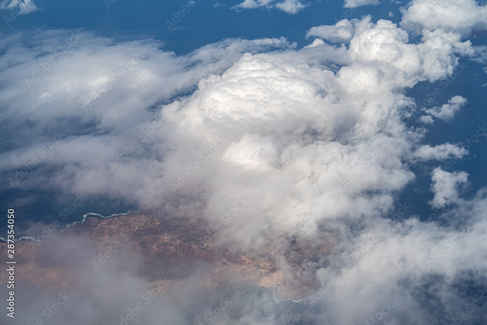 Clearing in clouds showing the Lanzarote volcanic island in the Canary Islands, Spain
