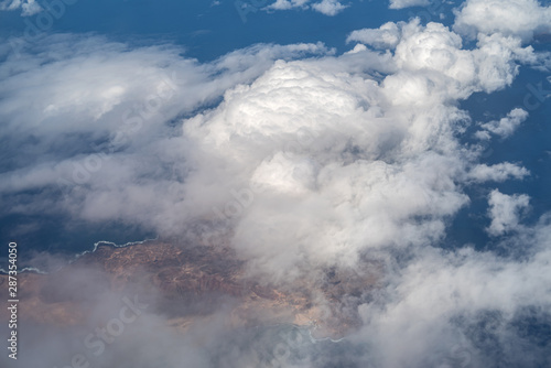 Фотография Clearing in clouds showing the Lanzarote volcanic island in the Canary Islands,