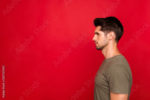 Obraz na plátně Profile photo of macho guy looking empty space wear grey t-shirt isolated on red