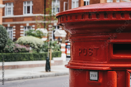 Fototapeta Red post box on a street in London, UK.