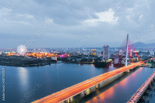 Han River Bridge (Cau Song Han) over the Han River in Da Nang, central Vietnam. Da Nang skyline cityscape by twilight period