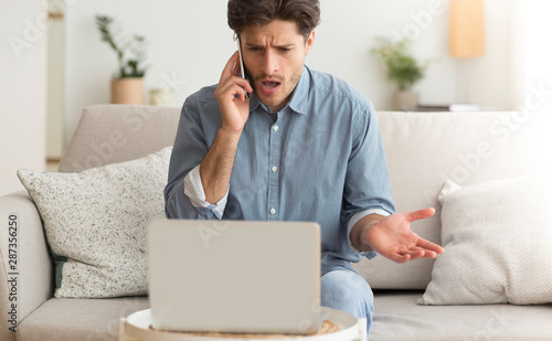 Angry Man Complaining About Problems By Cellphone Sitting On Couch