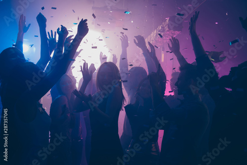 Canvas Print Close up photo of many party people dancing purple lights confetti flying everyw