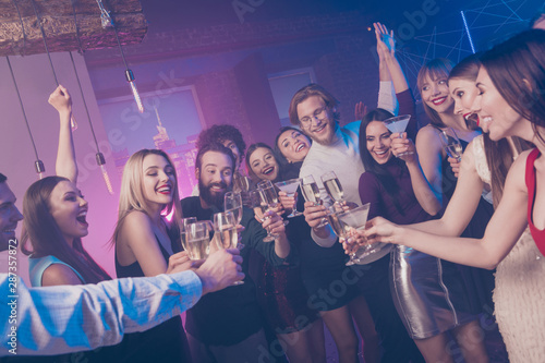 Portrait of nice adorable glamorous smart attractive cheerful cheery glad ladies and guys having fun clinking wineglasses birthday tradition surprise at fogged lights nightclub indoors