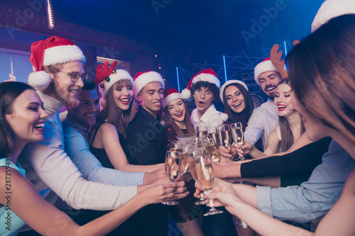 Portrait of nice-looking attractive glamorous diverse stylish cheerful positive girls and guys having fun festive congrats greetings nightlife amusement in luxury place nightclub indoors