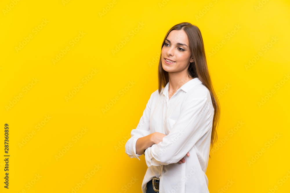 Young woman over isolated yellow background looking to the side Young woman over isolated yellow background looking to the side