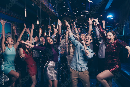 Nice attractive lovely smart glamorous stylish fashionable cheerful glad ecstatic positive girls and guys having fun chill out bachelor graduate festive event tradition in luxury place nightclub