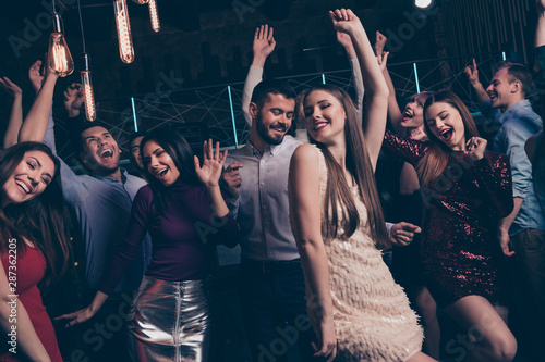 Nice-looking attractive lovely glamorous shine cheerful cheery glad positive elegant stylish diverse ladies and gentlemen having fun festal occasion in modern fashionable luxury place indoors