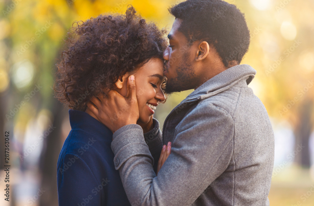 Portrait of sweet afro couple cuddling in the park Portrait of sweet afro couple cuddling in the park
