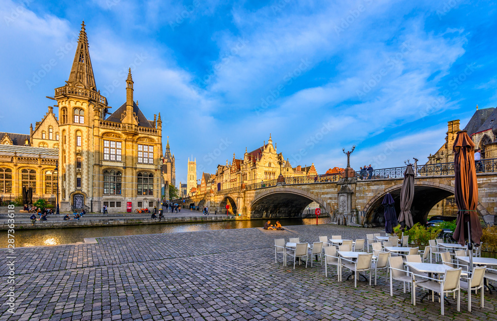 View of Graslei, Korenlei quays, Leie river and St Michael's bridge in the historic city center in Ghent (Gent), Belgium. Architecture and landmark of Ghent. Sunset cityscape of Ghent.