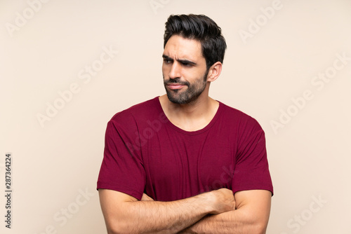 Handsome young man over isolated background thinking an idea
