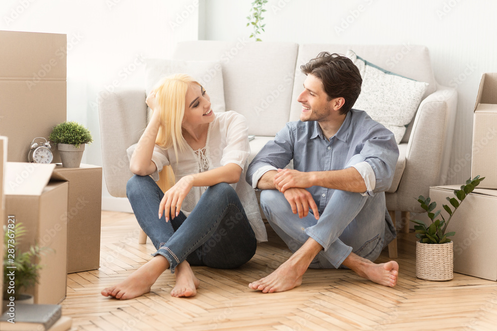 Spouses Relaxing Sitting Among Moving Boxes On Floor Indoor Spouses Relaxing Sitting Among Moving Boxes On Floor Indoor