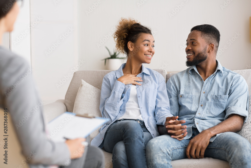 Cheerful Afro Couple Sharing News With Marital Therapist After Reconciliation Cheerful Afro Couple Sharing News With Marital Therapist After Reconciliation