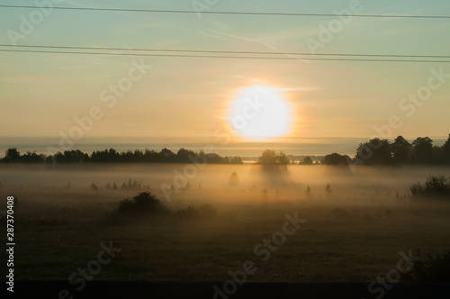 A summer sunrise with tender perl colors and mistic mist 