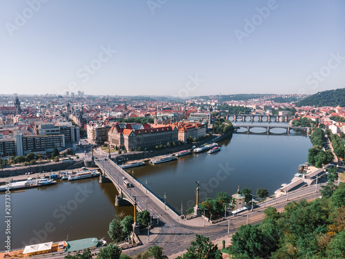 Scenic summer sunrise aerial view of the Old Town pier architecture and Charles Bridge over Vltava river in Prague, Czech Republic, travel tour to Europe concept design. © Sergey