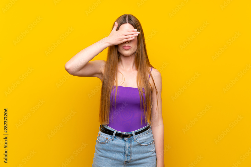 Young woman over isolated yellow background covering eyes by hands. Do not want to see something Young woman over isolated yellow background covering eyes by hands. Do not want to see something