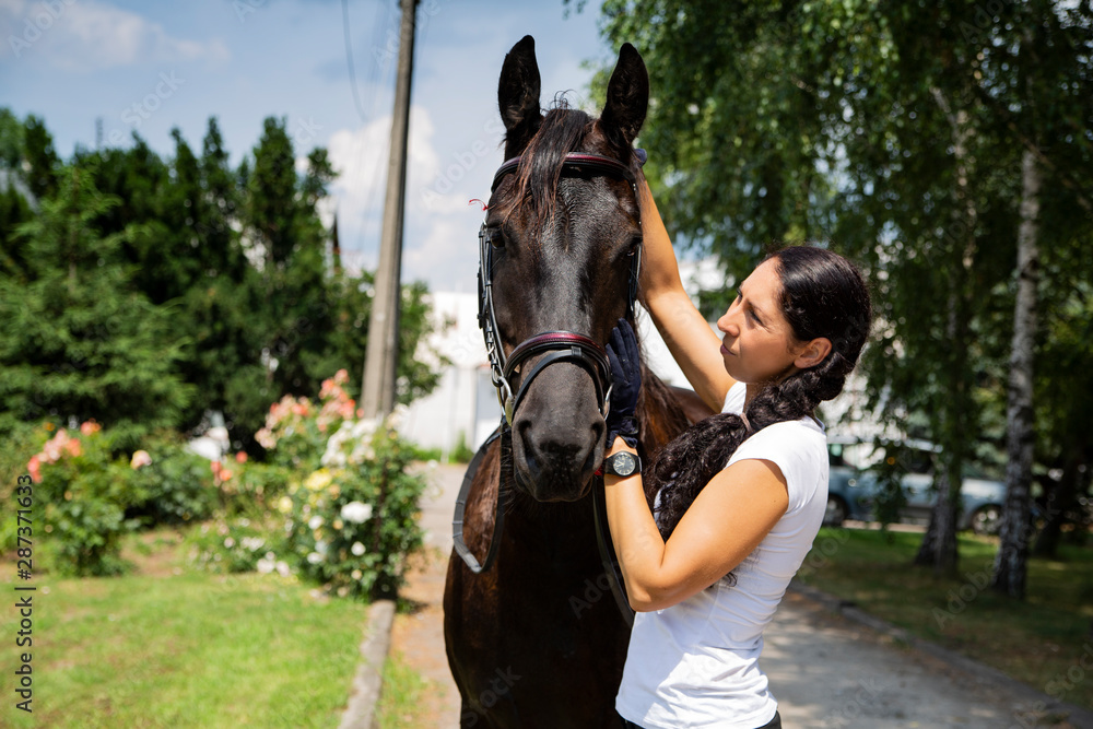 Obraz premium In stable. Horse riding, woman and horse