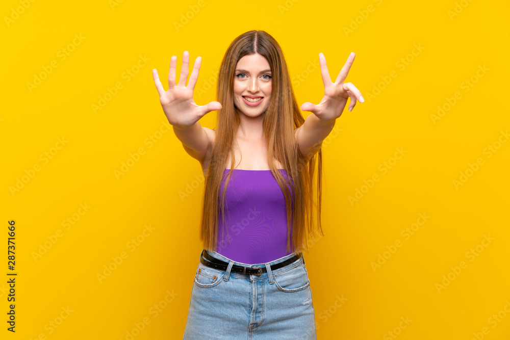 Young woman over isolated yellow background counting eight with fingers Young woman over isolated yellow background counting eight with fingers