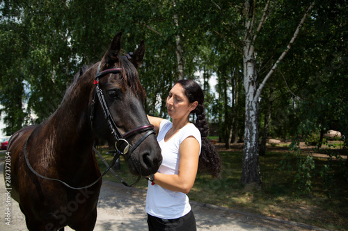 A woman and a horse at the stud. Horse Riding, © JacZia