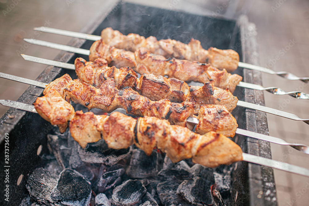 Juicy slices of meat with sauce prepare on fire shish kebab . BBQ outside. Juicy slices of meat with sauce prepare on fire shish kebab . BBQ outside.