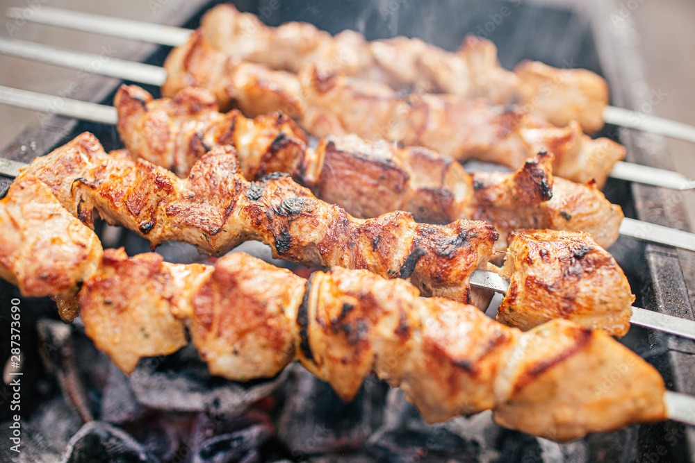 Juicy slices of meat with sauce prepare on fire shish kebab . BBQ outside.